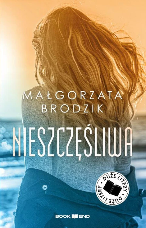 Nieszczęśliwa. Duże Litery, Małgorzata Brodzik